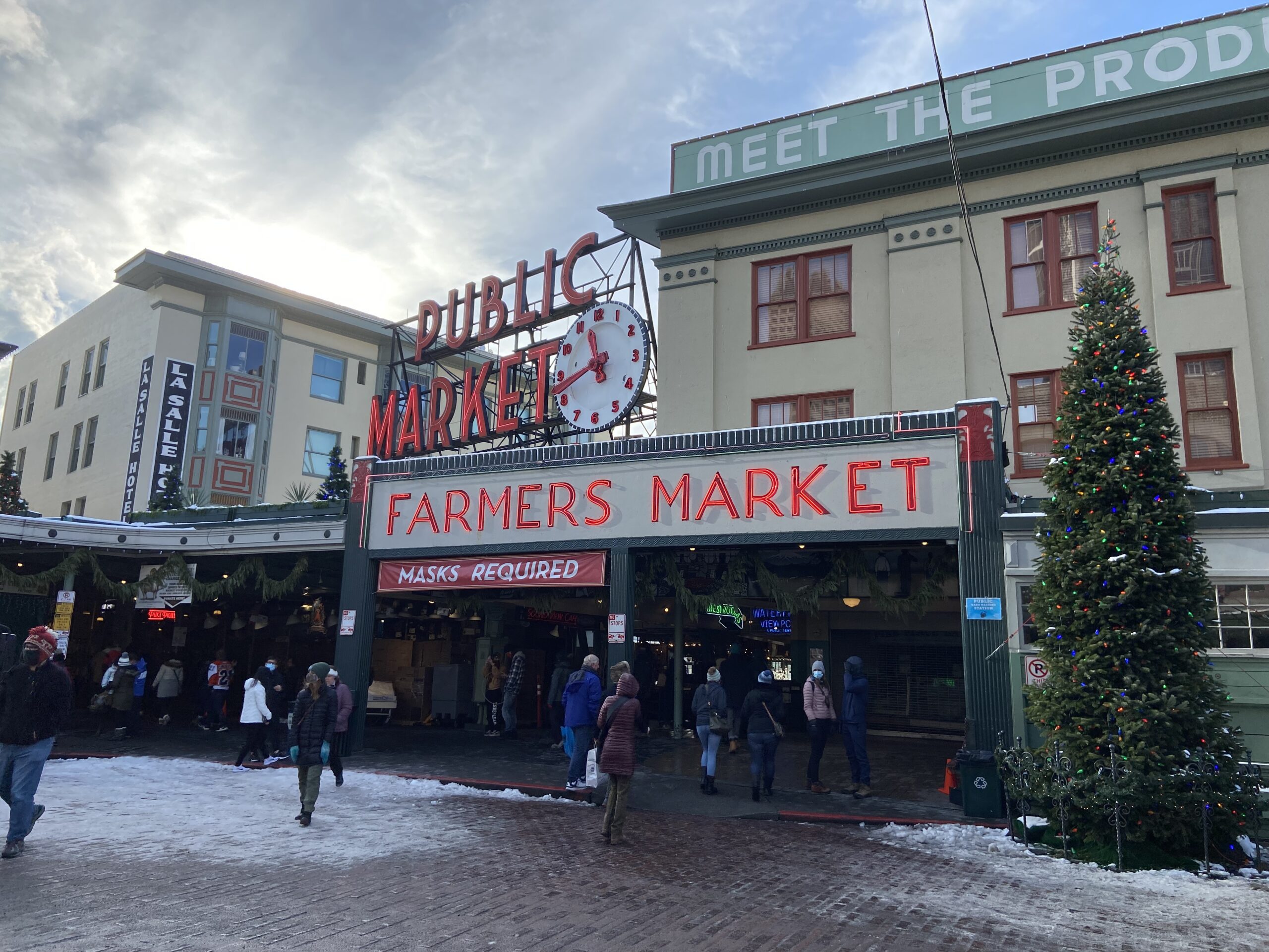 Visitors walking into Pike Place Market